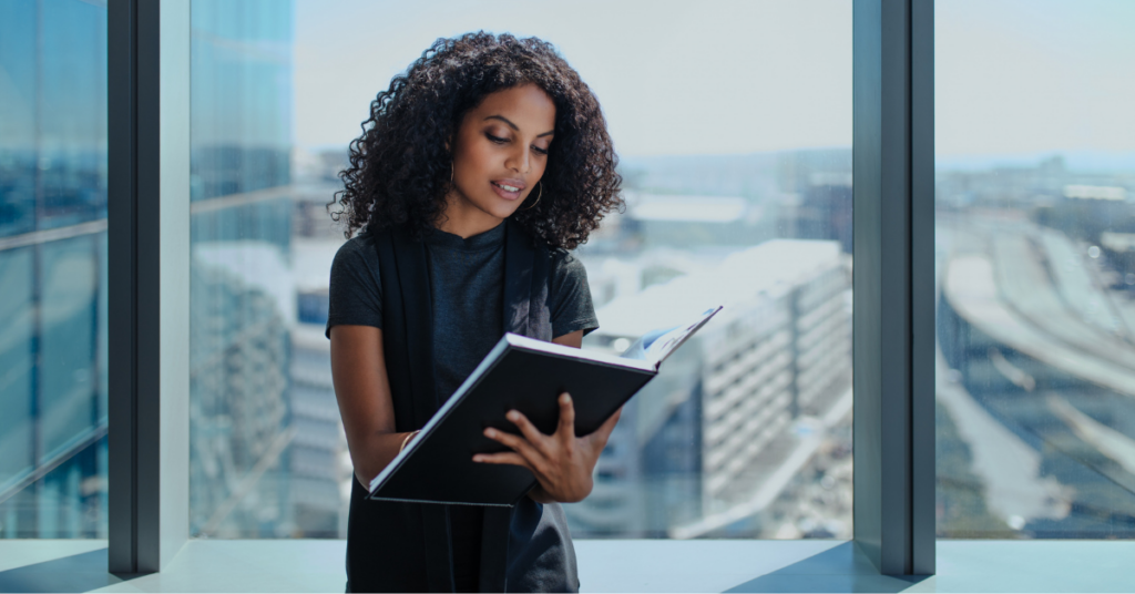 woman looking at a binder with information on Active vs. Passive Sustainable Funds